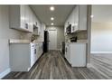 Modern kitchen boasting white cabinets, black hardware, sleek countertops, and stainless steel appliances at 1735 Council Dr, Sun City Center, FL 33573