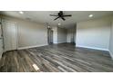 Open living area featuring modern flooring, neutral paint, ceiling fan, and ample natural light at 1735 Council Dr, Sun City Center, FL 33573
