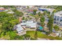 Aerial view of home with lush surroundings and screened-in pool in a vibrant neighborhood at 3620 E Tampa Cir, Tampa, FL 33629