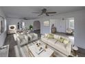 Bright living room with modern furniture and plenty of natural light, open to the dining area at 602 E Laura St, Plant City, FL 33563