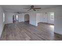 Spacious living room featuring modern flooring, white walls, and a ceiling fan for a bright, airy feel at 602 E Laura St, Plant City, FL 33563