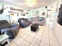 Cozy living room with tile floors, comfortable seating, and bright, airy atmosphere at 7943 Woodvine Cir, Tampa, FL 33615