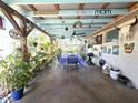 Outdoor dining area featuring an open-air structure with decorative features, potted plants and a grill at 7943 Woodvine Cir, Tampa, FL 33615