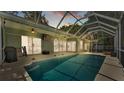 Relaxing screened pool area with ceiling fans and outdoor furniture, perfect for entertaining at 2332 Timbergrove Dr, Valrico, FL 33596
