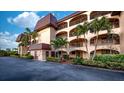 Multi-story condo building with lush landscaping and multiple balconies providing outdoor living at 23465 Harborview Rd # 223, Punta Gorda, FL 33980