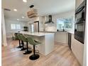 Bright kitchen featuring modern appliances, a center island, and stylish green bar stools at 320 Palm Ne Is, Clearwater Beach, FL 33767