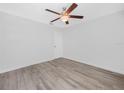 Empty bedroom featuring wood-look floors and a ceiling fan at 3811 N Oak Dr # E62, Tampa, FL 33611