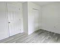Bright bedroom featuring freshly painted walls and modern, light gray flooring at 702 Hillsboro St, Plant City, FL 33563