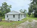 Well-maintained home with a gray exterior and light trim, surrounded by a spacious yard at 702 Hillsboro St, Plant City, FL 33563