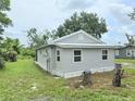 Single-story home boasting a light gray exterior, clean lines, and ample outdoor space at 702 Hillsboro St, Plant City, FL 33563