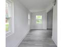 Bright hallway with fresh white walls and attractive gray wood-look flooring at 702 Hillsboro St, Plant City, FL 33563