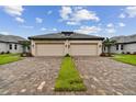 Two-car garage, brick pavers, and curb appeal at 18174 Cherished Loop, Bradenton, FL 34211