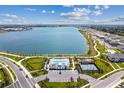 Aerial view of community lake, pool, playground, and tennis courts at 1884 Bilge Ln, Sarasota, FL 34240