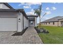 Front entry with walkway, landscaping, and two-car garage at 18039 Cherished Loop, Bradenton, FL 34211