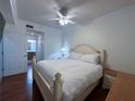 Bright bedroom with a king-size bed and en-suite bathroom access at 7121 River Hammock Dr # 107, Bradenton, FL 34212