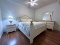 Bright bedroom with a white bed frame and wood floors at 7121 River Hammock Dr # 107, Bradenton, FL 34212
