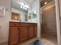 Bathroom boasts double vanity, a large mirror, and a walk-in shower at 7121 River Hammock Dr # 107, Bradenton, FL 34212