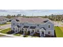 Aerial view showcasing townhomes' exterior, landscaping, and community layout at 7424 Cabin Ln, Sarasota, FL 34240