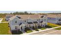 Aerial view of gray and white two-story townhomes in a well-manicured community at 7428 Cabin Ln, Sarasota, FL 34240