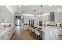 Spacious kitchen with white cabinets, quartz countertops and gold hardware at 289 Vistera Blvd, Nokomis, FL 34275