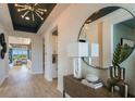 Bright and airy entryway with wood-look floors, a large mirror and modern decor at 289 Vistera Blvd, Nokomis, FL 34275
