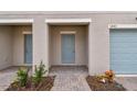 New townhouse entry with light blue door and brick walkway at 5443 Tripoli Dr, Palmetto, FL 34221