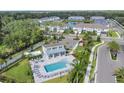 Community pool with cabana, lounge chairs, and surrounding landscape at 322 Via Anina Dr, Sarasota, FL 34243