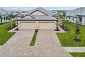 Two-story home with a double-wide driveway and manicured lawn at 18019 Cherished Loop, Bradenton, FL 34211