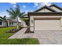 Two-story home with a two-car garage and walkway at 18019 Cherished Loop, Bradenton, FL 34211