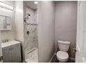 Modern bathroom featuring a walk-in shower with marble tile and updated fixtures at 2722 Nancy St, Sarasota, FL 34237