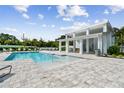 Community pool with a clubhouse and plenty of seating at 321 Via Tuscany Ave, Sarasota, FL 34243