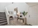Bright foyer with stairs, table decor, and luxury vinyl plank flooring at 16896 Fiesta Dr, Port Charlotte, FL 33953