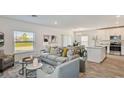 Open-concept living room and kitchen with stainless steel appliances at 16896 Fiesta Dr, Port Charlotte, FL 33953