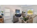 Well-lit living room with modern furniture and neutral color palette at 16896 Fiesta Dr, Port Charlotte, FL 33953