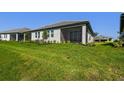 Lush backyard with a screened-in lanai at 18063 Cherished Loop, Bradenton, FL 34211