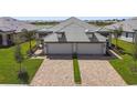 New villa with a large driveway, two car garage and a well manicured lawn at 18063 Cherished Loop, Bradenton, FL 34211