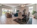 Sun-filled living room and dining area with modern furniture, neutral paint, and large sliding glass doors at 17126 Savory Mist Cir, Bradenton, FL 34211