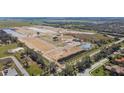 An aerial view of the community under construction with community pond, green spaces, and single Gathering homesites at 7533 Nighthawk Dr, Sarasota, FL 34241