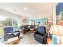 Comfortable living room with a plush sectional sofa and a large glass door offering natural light at 18149 Dillon Ave, Port Charlotte, FL 33954