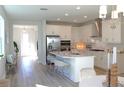 Spacious, open-concept kitchen with stainless steel appliances, an island with seating, and ample natural light at 229 Vistera Blvd, North Venice, FL 34275