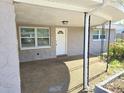 Inviting front porch with a stone facade, offering a cozy entrance to the home at 3542 Trask Dr, Holiday, FL 34691
