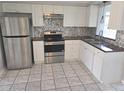 Well-equipped kitchen with stainless steel appliances and ample cabinet space at 3542 Trask Dr, Holiday, FL 34691