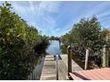 Waterfront views from this private dock, perfect for enjoying the serene canal and lush vegetation at 468 Ceil Dr, Nokomis, FL 34275