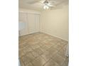 Bedroom featuring tile floor, neutral walls and a closet with sliding doors at 5014 Galaxy Dr, New Port Richey, FL 34652