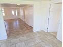 Spacious foyer featuring tile flooring and a front door with decorative glass at 5014 Galaxy Dr, New Port Richey, FL 34652