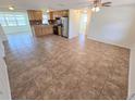 Open concept living space with tile flooring, kitchen, and natural light at 5014 Galaxy Dr, New Port Richey, FL 34652