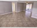 Spacious living area with neutral paint, tile floors and a screened patio with sliding glass doors at 7352 Sequoia Dr, New Port Richey, FL 34653
