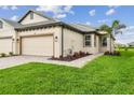 Well-maintained home featuring a brick driveway, lush green lawn, and tasteful landscaping at 17982 Cherished Loop, Bradenton, FL 34211