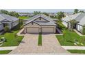 Charming paired villas with well-manicured lawns and driveways constructed with eye-catching brick pavers at 17986 Cherished Loop, Bradenton, FL 34211