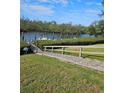 A well-maintained dock and waterway with tropical foliage at 8744 54Th W Ave # 8744, Bradenton, FL 34210